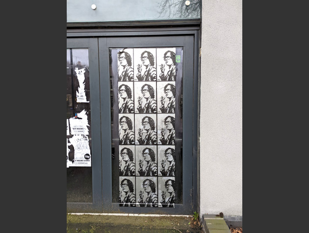 Paste-up featuring the same monochrome image of Jarvis Cocker holding a cigarette repeated