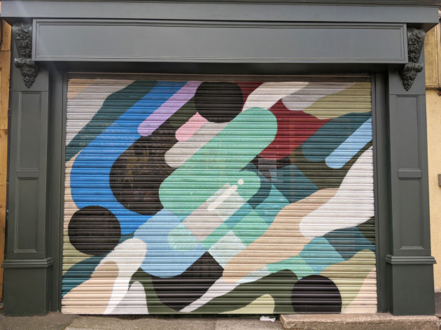 Shop shutters painted with colourful abstract shapes