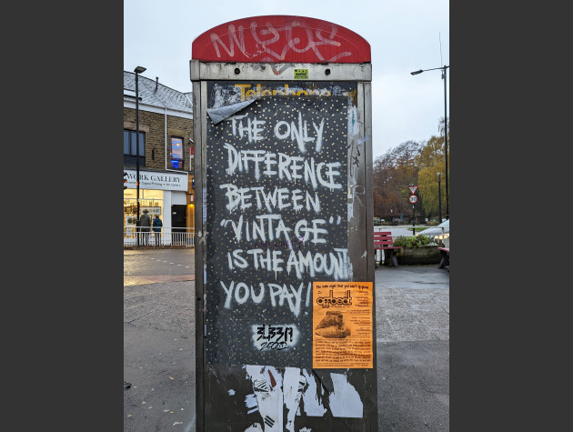 Paste-up on the side of a phonebox with the words 'The Only Difference Between 'Vintage' is the Amount You Pay'