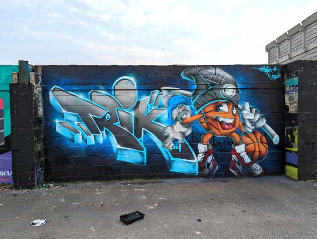 Simple style graffiti writing and smiling basketball character