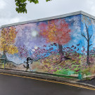 Large wall mural depicting autumnal trees losing their leaves