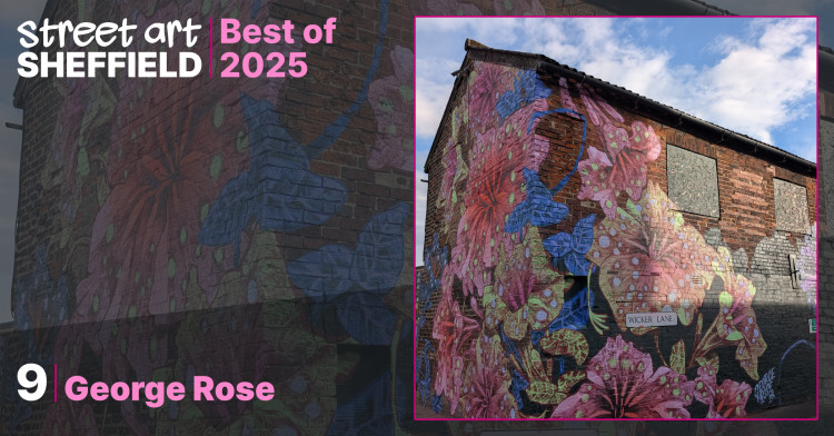 Mural covering the corner of an old red brick building featuring oversized, stylized flowers in vibrant shades of pink, blue and lime green