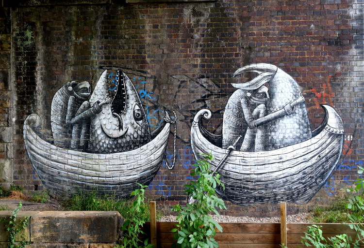 Black and white mural of two boats each containing a rower holding one half of the same fish