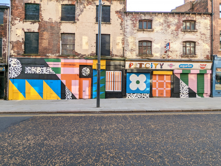 Colourful abstract patterns on boarded up shops