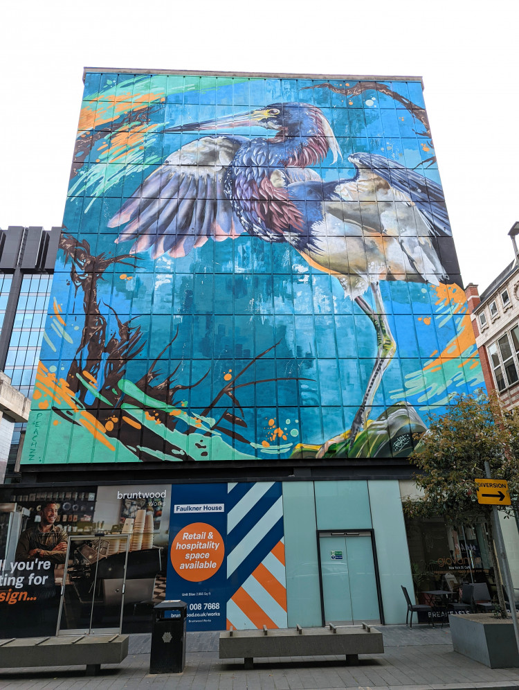 Large wall mural of a heron with open wings