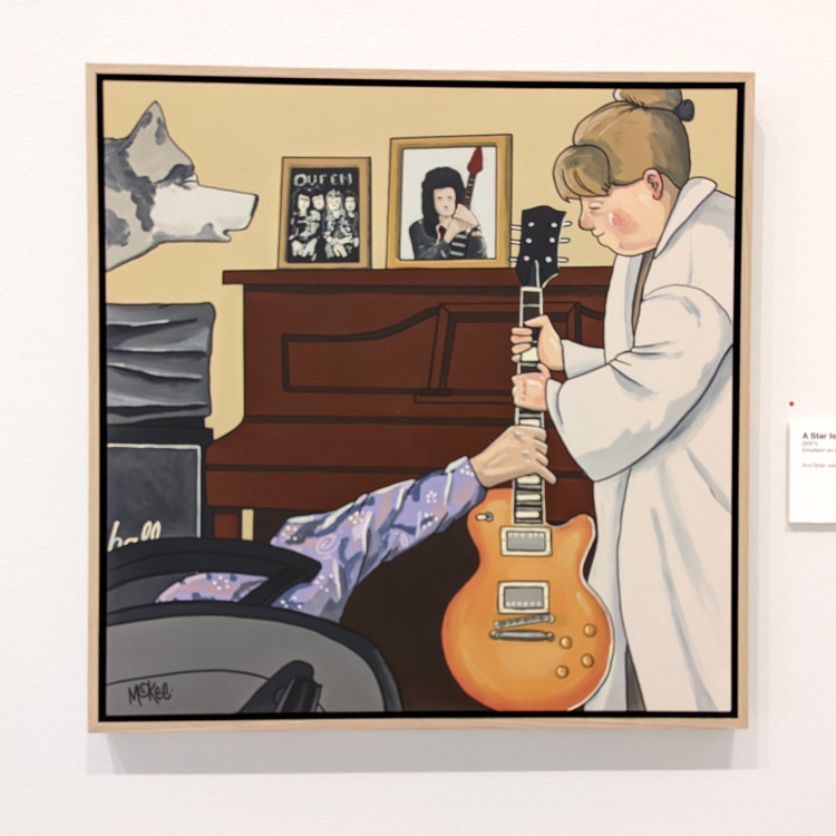 A painting showing a woman passing an electric guitar to a man that has fallen over in his chair, a picture of Brian May is seen in the background