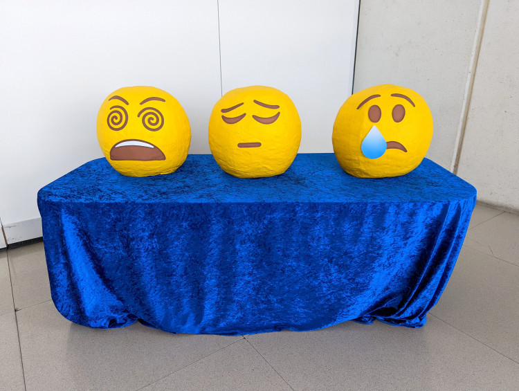 Three paper mache emoji masks