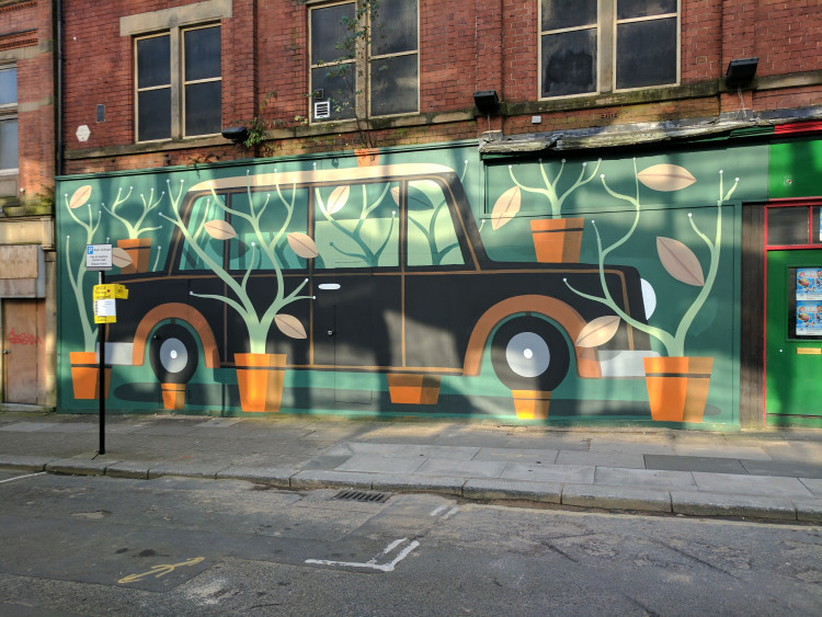 Mural of a car surrounded by pot plants