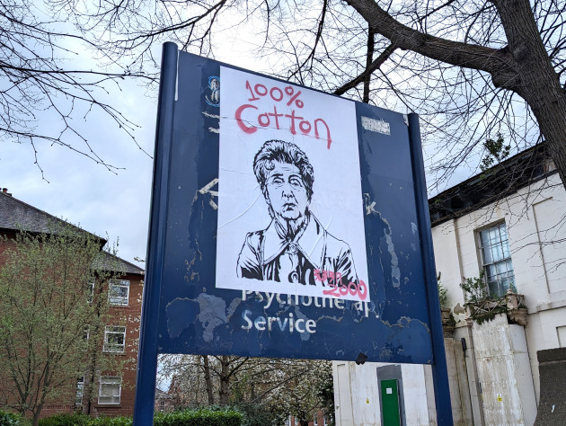 Paste-up featuring an illustration of the character Dot Cotton with a cigarette hanging out of her mouth and the words '100% cotton' sprayed across it