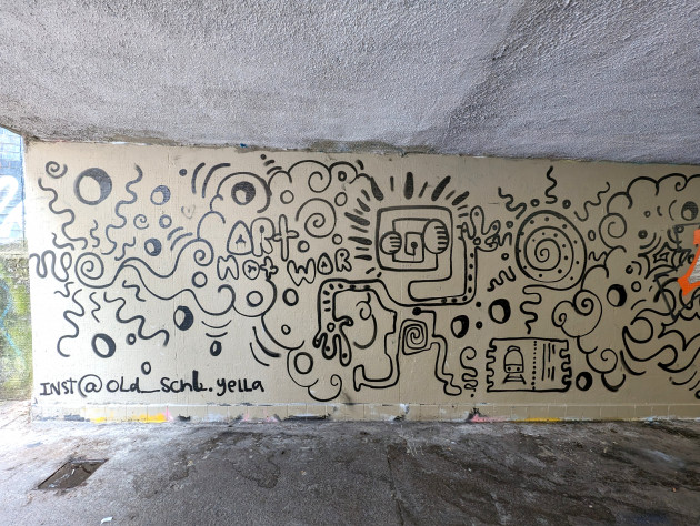 Doodle style mural with the words 'Art not war'