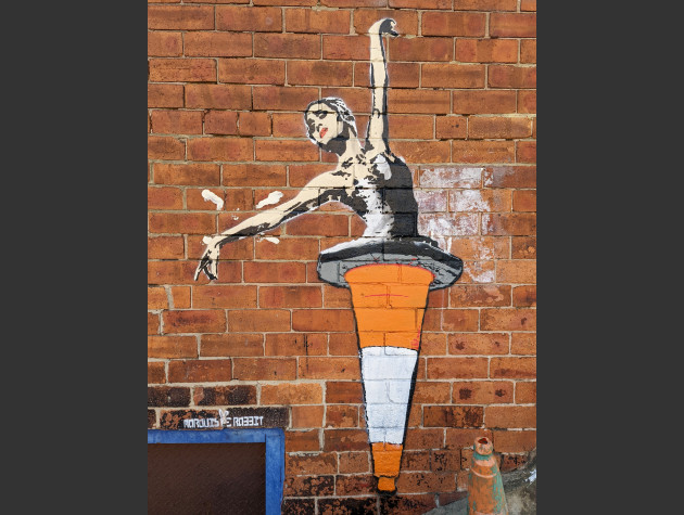 Stencil art work by Marquis De Rabbit of a female ballet dancer in a traffic cone