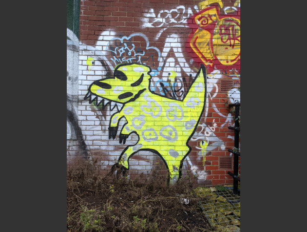 Spray painted yellow dinosaur character