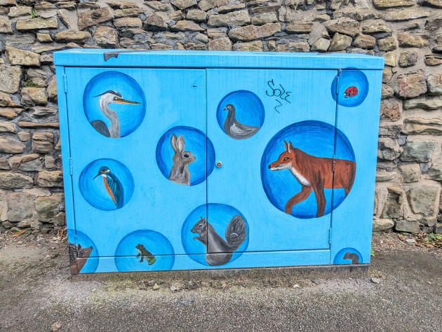 Telecom cabinet painted with a design featuring different local wild animals including a heron, fox and squirrel