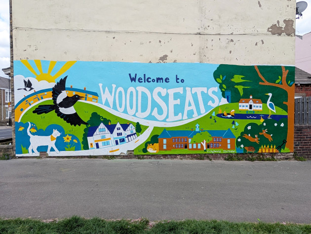 Mural illustrating local wildlife and different locations around Woodseats with the words 'Welcome to Woodseats' written across the middle of the artwork