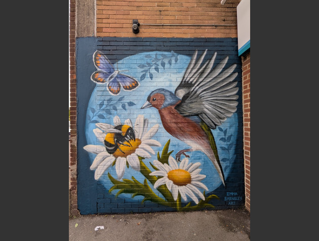 Large mural featuring a bird, bee and butterfly