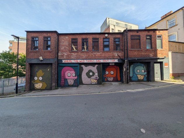 Five shutters, each painted with a different character wearing a dog costume hat