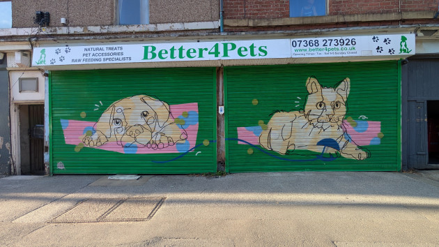 A pair of shutters painted with a puppy and a kitten in a line drawing style