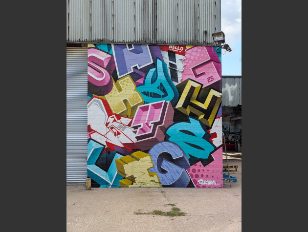 Mural comprising of different letters of different font styles in a muddled heap like formation