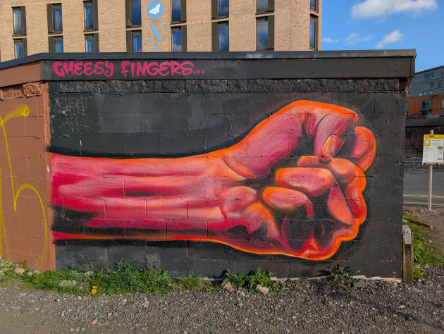 Mural of an outstretched arm with clinched fist.