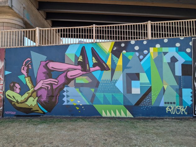 Colourful abstract mural by R U OK featuring a man falling backwards