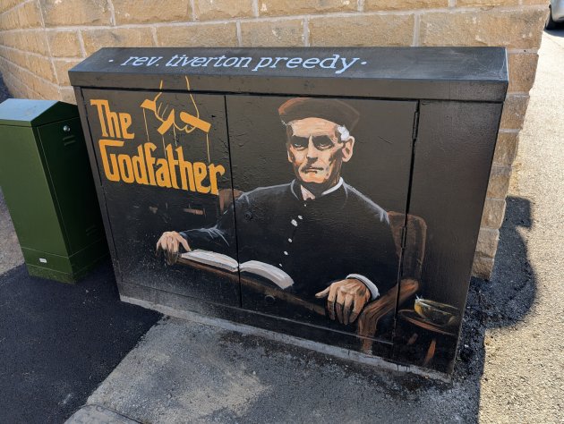 Cabinet painted with a mural of Reverend Tiverton Preedy and the words 'The Godfather'
