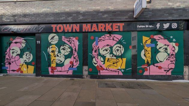 Mural in four parts showing different perspectives of a face