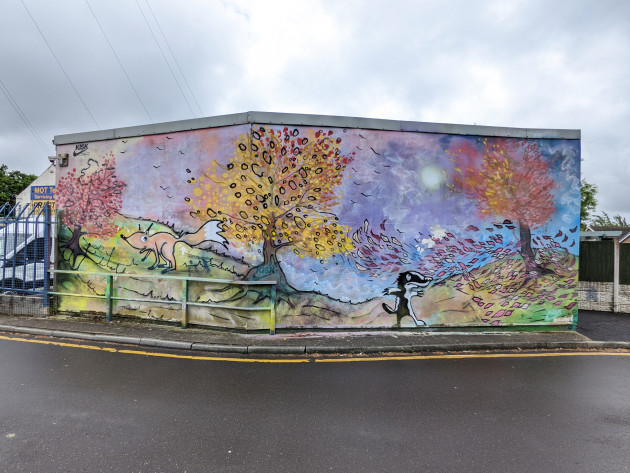 Large wall mural depicting autumnal trees losing their leaves