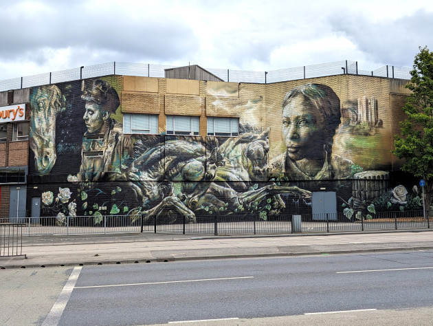 Part of a huge mural featuring a miner with pit pony, some racehorses, a black female NHS doctor and Conisbrough castle