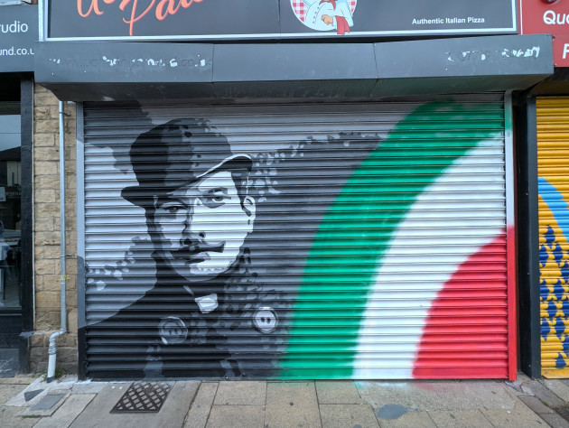 Painted shutters featuring Giacomo Puccini next to the colours of the Italian flag