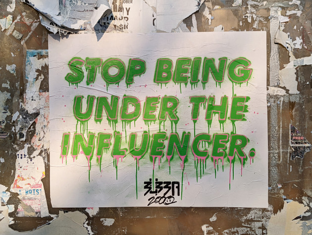 Paste-up with the words 'Stop Being Under the Influencer'