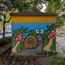 Cartoon style mural of a snail and mushrooms