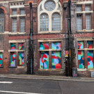Wide angle photo of the old Salvation Army Citadel, with Luke Passey's abstract mural shown in full 