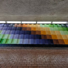 Another close up of the mural featuring diaganol waves of colour using an orange, green and purple colour palatte