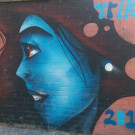 Mural of a blue skinned woman with long dark hair