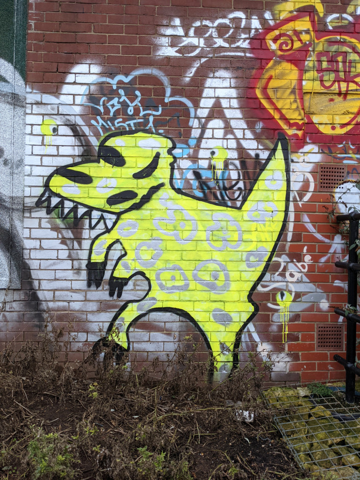 Spray painted yellow dinosaur character